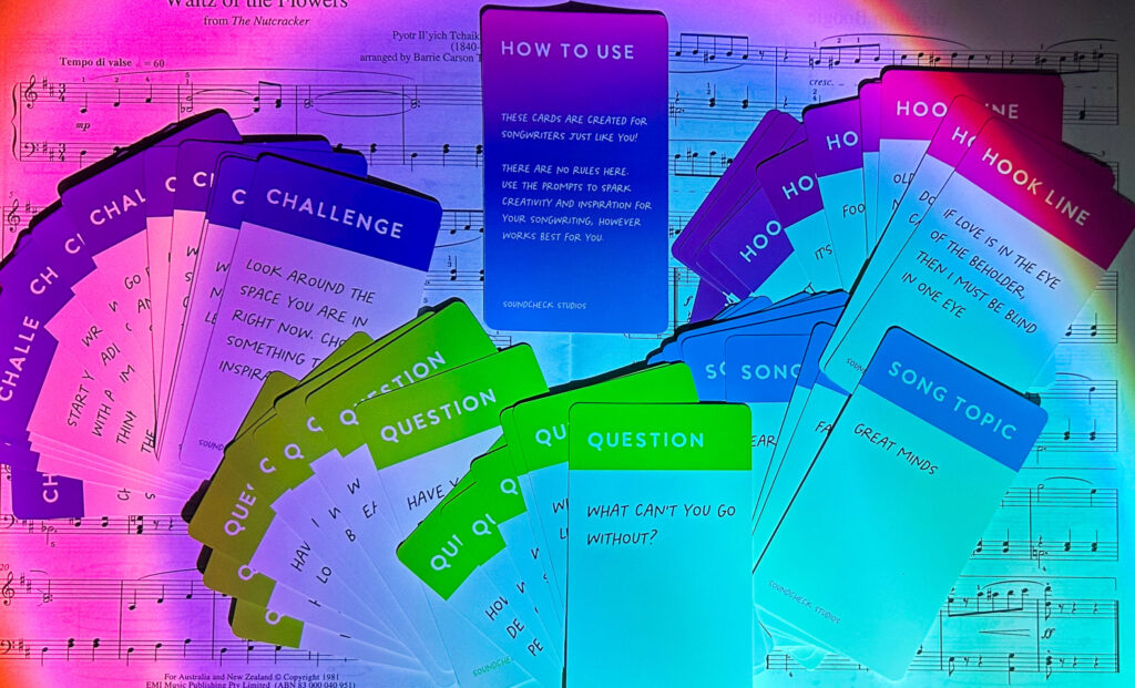 A collection of inspiring songwriting prompt cards on classical sheet music